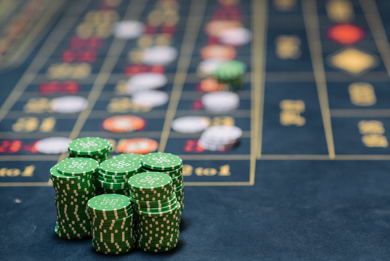 services-img Stack of green poker chips on a casino table, highlighting the gambling theme.